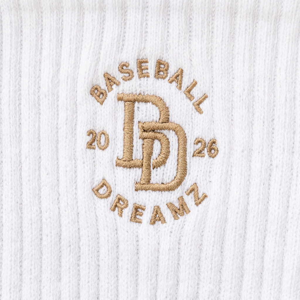 Close-up of the Baseball Dreamz embroidered logo on white ribbed crew socks